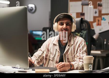 Portrait of Asian Man Working at Creative Office Desk Stock Photo