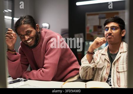 Two Young Men Collaborating in Creative Office Stock Photo