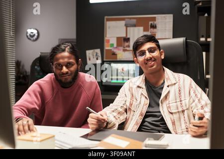 Male Colleagues Collaborating on Video Editing Stock Photo
