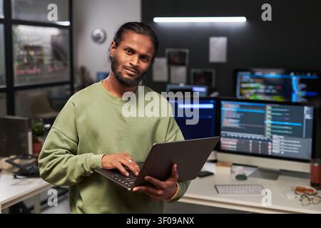 Portrait of Web Engineer Using Laptop in Software Office Stock Photo