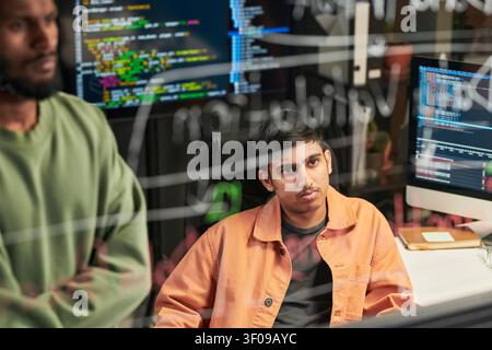 Man Reviewing Code with Team in Software Development Office Stock Photo