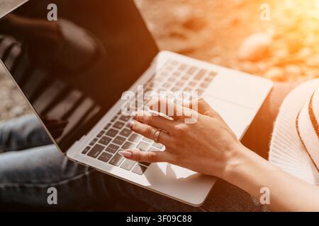 Laptop typing freelance close up of woman hand typing on portable computer outdoors representing remote work lifestyle Stock Photo