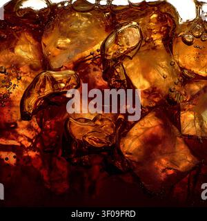 Iced dark beverage with amber cubes and sparkling bubbles Stock Photo