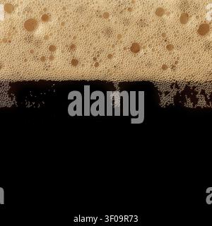 Dark beer foam texture with dense bubbles and black lager layer. Stock Photo