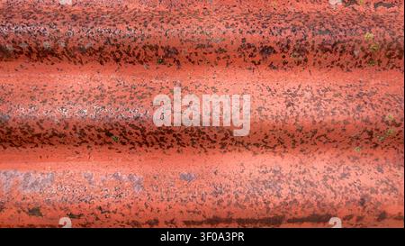 Close-Up of Rusty Red Corrugated Metal with Weathered Industrial Texture in Switzerland Stock Photo