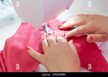 Sewing background with designers hands and sewing machine Stock Photo