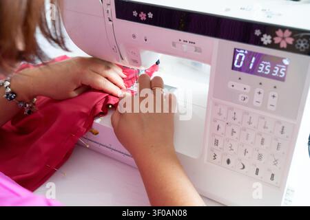 Sewing background with designers hands and sewing machine Stock Photo