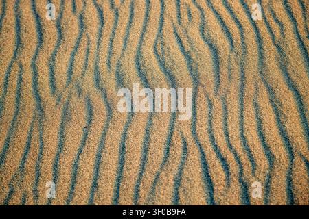 Hå, Norway - 14.06.2026: Wavy sand patterns on a shoreline with textured ridges and deep shadows under natural light Stock Photo
