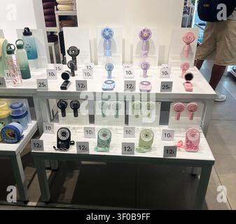 Personal hand-held cooling fans for sale in a railway station shop on Zaragoza-Delicias station concourse in Spain. Stock Photo
