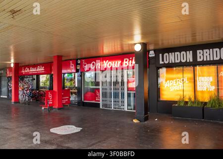 Shops on London Bridge Walk, a footway leading to London Bridge Station, Southwark, London, UK Stock Photo