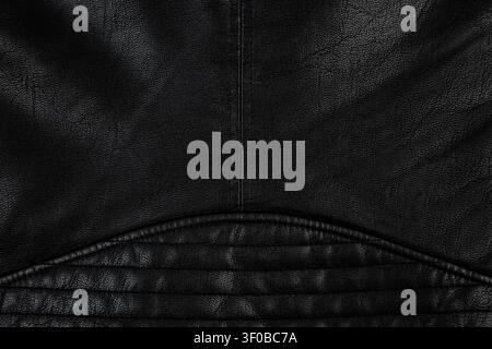 Close-up of black leather jacket texture with quilted stitching details. Stock Photo