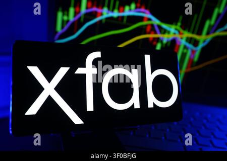 X Fab Silicon Foundries Se Logo Displayed On A Smartphone Screen In Front Of A Computer Showing Stock Market Financial Performance Charts Stock Photo
