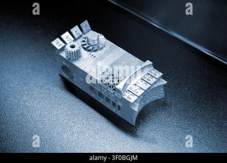 Small object metal calibration model printed on 3D printer. Detailed model printed on 3D printer from metal powder. Selective Laser Melting technologies SLM. Additive modern manufacturing. 3D printing Stock Photo