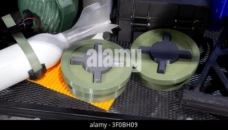 Anti-personnel high explosive mine printed on 3D printer. Mine created on 3D printer from molten plastic. Prototype of ammunition printed on 3D printer. Innovation modern new 3d printing technology Stock Photo