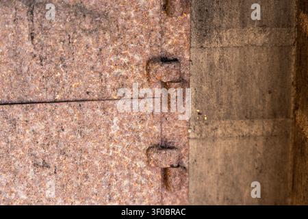 Detailed view of corroded iron surfaces showing signs of age and wear, with visible rivets connecting two sections Stock Photo