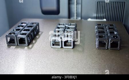 An object printed on a 3D printer on a work surface 3D printer. Object printed on 3D printer from molten plastic black color. Additive new modern manufacturing technology. 3D printing FDM technology Stock Photo