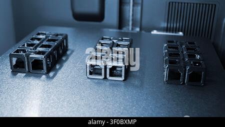 An object printed on a 3D printer on a work surface 3D printer. Object printed on 3D printer from molten plastic black color. Additive new modern manufacturing technology. 3D printing FDM technology Stock Photo