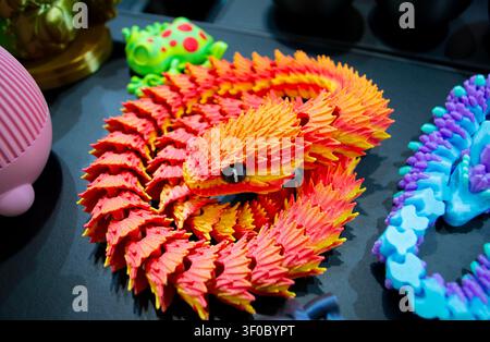 Object toy orange color printed on 3D printer. Model printed on 3D printer from molten plastic. FDM technology. Fused Deposition Modeling. Additive new modern manufacturing technology. 3D printing Stock Photo
