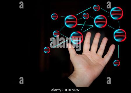 Hand extends towards glowing spheres connected by lines, representing digital networking and technology themes in a dark background setting Stock Photo