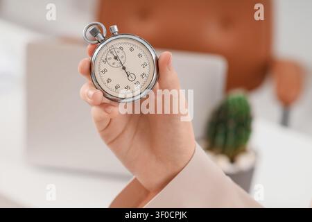 Hand holding a stopwatch showing time Stock Photo