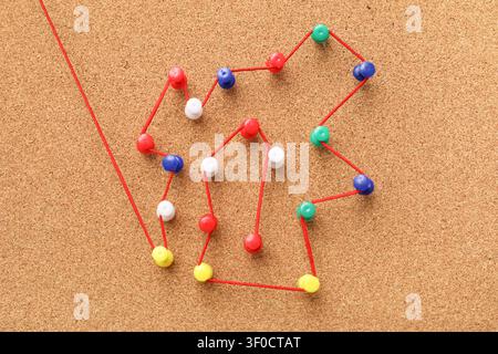 Connected pins with thread on board. Link concept Stock Photo