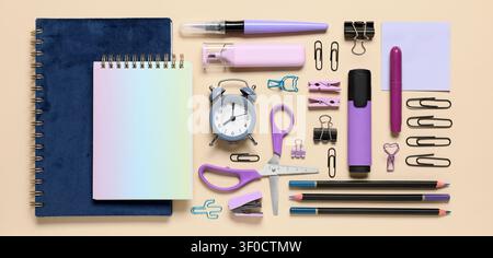 Flat lay of purple and blue office supplies on beige background Stock Photo