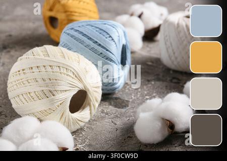 Cotton yarn balls with raw cotton on textured surface Stock Photo