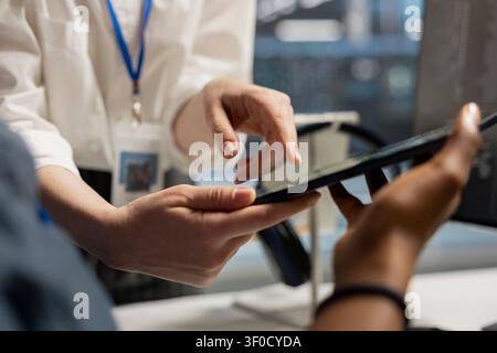 Engineering team reviews performance analytics on a digital tablet in a data center to optimize storage systems and resource use. Stock Photo