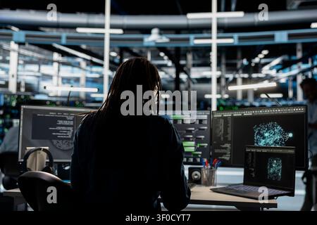 System operator uses a laptop computer in a data center to support failure detection and reliable server workflows. Stock Photo