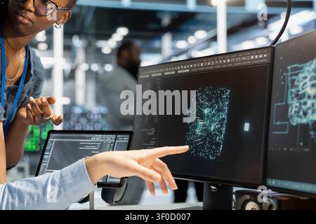Data center team uses a desktop computer in a data center to manage AI systems and optimize server infrastructure. Stock Photo
