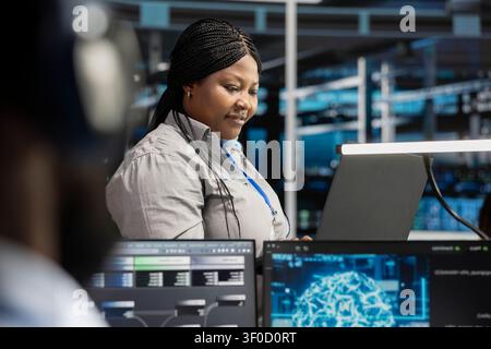 Pleased data center technician celebrates after configuring machine learning systems with AI technology in a data center. Stock Photo
