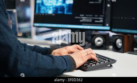 Administrator programs on a computer workstation in a high tech data center with generative AI assistance. Stock Photo