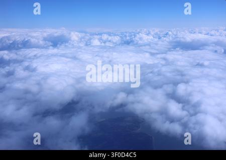 Aerial View Looking Down on an Endless Sea of White Fluffy Clouds Stock Photo