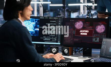 System administrators in server room struggle with computer bugs while working with AI. Stock Photo