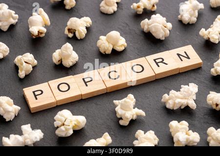 Freshly popped popcorn isolated on a black chalkboard background, simple composition for stock photography Stock Photo