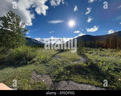 Sunlight breaks through light clouds over the peaks of Kananaskis Country, Alberta, Canada. Stock Photo