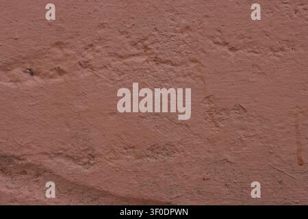 Brown concrete wall texture. Damaged, uneven wall for background. Stock Photo