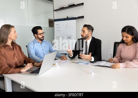 Diverse professionals discussing marketing strategy in office Stock Photo