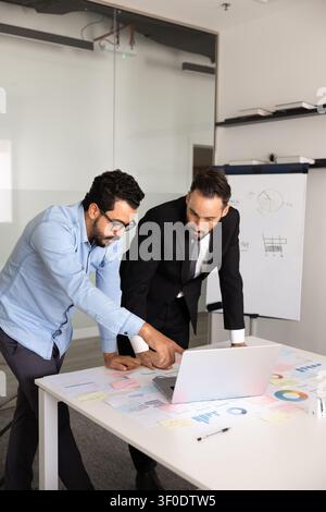 Colleagues working together on marketing strategy using laptop Stock Photo
