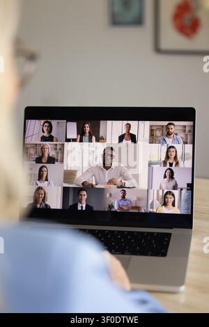 Multiethnic businesspeople attending online video conference, closeup laptop screen view Stock Photo