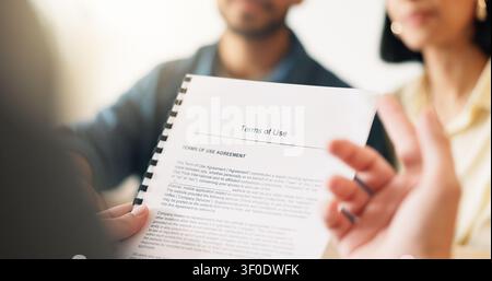Hands, lawyer and reading document with couple, finance contract and agreement for terms of use. People, consultation or attorney with paperwork Stock Photo