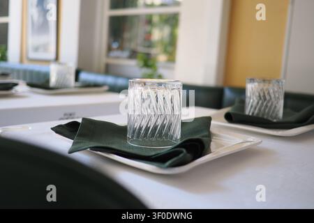 Elegant table setting with glassware and napkins in sunlight Stock Photo