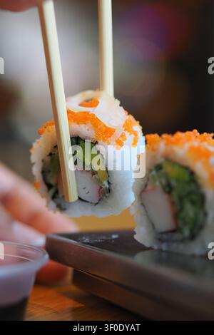 Sushi delight wrapped in vibrant flavors on a wooden table Stock Photo