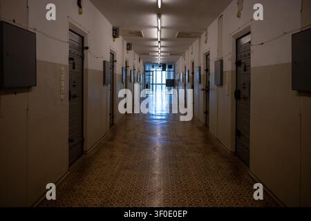Long corridor lined with preserved cell doors inside the Berlin-Hohenschonhausen Memorial in Berlin, Germany. Stock Photo