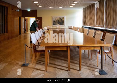Wood-paneled conference room with long table and covered chairs in the Berlin Stasi Museum, Berlin, Germany. Stock Photo