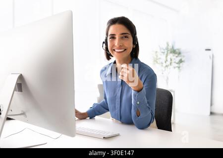 Portrait of happy support agent assisting clients online Stock Photo