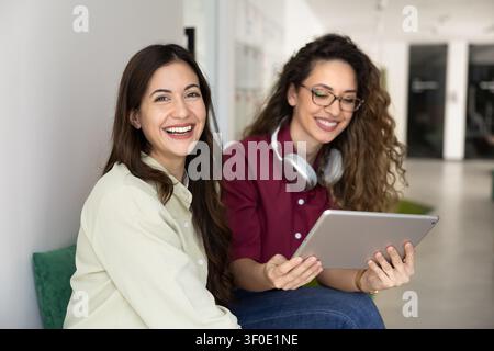 Colleagues collaborating on project, smiling, posing for professional portrait Stock Photo