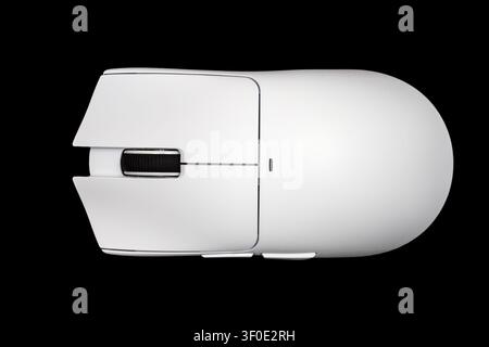 A white computer mouse on a black background. Close-up of a modern computer mouse Stock Photo