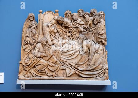 Berlin, Germany - 23 May 25: Carved relief showing the Dormition of Mary displayed at the Bode Museum in Berlin, Germany. Stock Photo