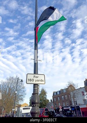 Solidarity - Palestinian flag flying from a lamp post on Grove Road, Mile End, in the London Borough of Tower Hamlets, East London, UK. Stock Photo
